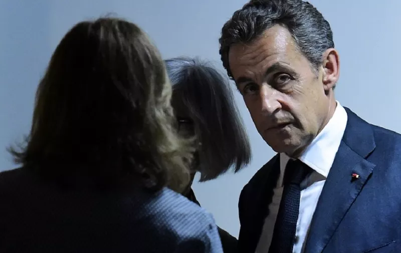 French former president Nicolas Sarkozy (R) looks on after giving a press conference with Spanish Prime Minister, at the Spanish ruling Popular Party (PP) headquarters in Madrid, on June 29, 2015. Former French president Nicolas Sarkozy today urged the European Union not to "yield" to Greece following the break up of talks between Athens and its international bailout creditors. AFP PHOTO / GERARD JULIEN