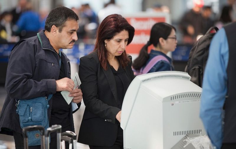 CHICAGO, IL - JUNE 02: Passengers check-in for flights with United Airlines at O'Hare Airport on June 2, 2015 in Chicago, Illinois. United travelers experienced widespread delays this morning after the airline was forced to ground flights after experiencing computer problems. The issue coincided with reports of bomb threats being made against several airlines, including a United.   Scott Olson/Getty Images/AFP