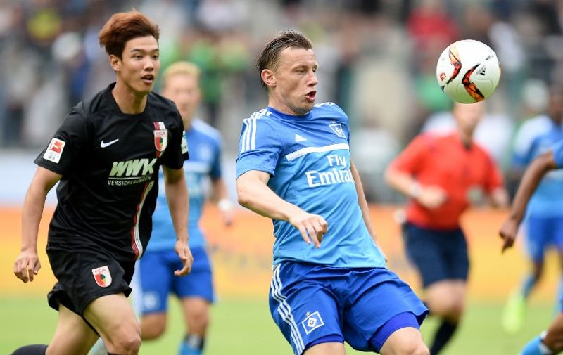 Hamburg's midfielder Ivica Olic and Augsburg's South Korean defender Jeong-Ho Hong vie for the ball during the German Telkom Cup 2015 final football match FC Augsburg and Hamburger SV in Moenchengladbach, western Germany on July 12, 2015. AFP PHOTO / PATRIK STOLLARZ

DFL RULES TO LIMIT THE ONLINE USAGE DURING MATCH TIME TO 15 PICTURES PER MATCH. IMAGE SEQUENCES TO SIMULATE VIDEO IS NOT ALLOWED AT ANY TIME. FOR FURTHER QUERIES PLEASE CONTACT DFL DIRECTLY AT + 49 69 650050. / AFP / PATRIK STOLLARZ