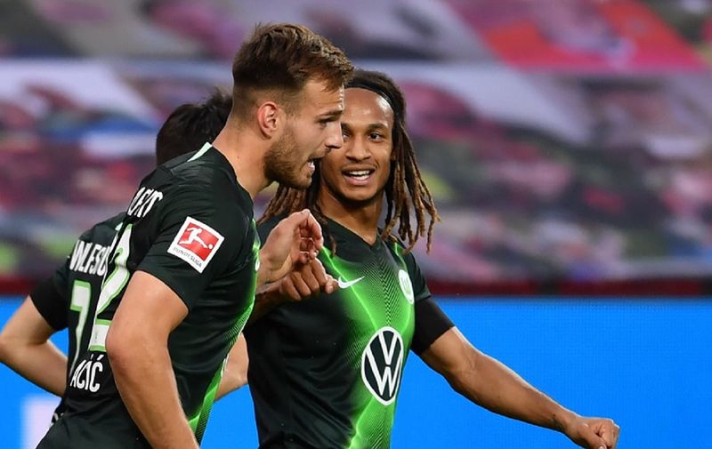 Wolfsburg's Croatian defender Marin Pongracic (L) and Wolfsburg's Swiss defender Kevin Mbabu celebrate the 0-1 during the German first division Bundesliga football match Bayer 04 Leverkusen v VfL Wolfsburg on May 26, 2020 in Leverkusen, western Germany. (Photo by Marius Becker / POOL / AFP) / DFL REGULATIONS PROHIBIT ANY USE OF PHOTOGRAPHS AS IMAGE SEQUENCES AND/OR QUASI-VIDEO
