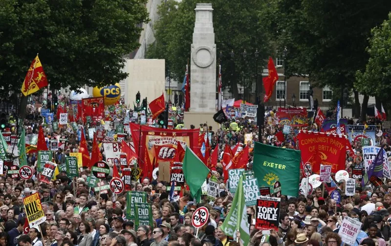 Demonstrators walk past the Cenotaph on Whitehall as they take part in a protest march against the British government's spending cuts and austerity measures in London on June 20, 2015. The national demonstration against austerity was organised by People's Assembly against government spending cuts.    
 AFP PHOTO / JUSTIN TALLIS