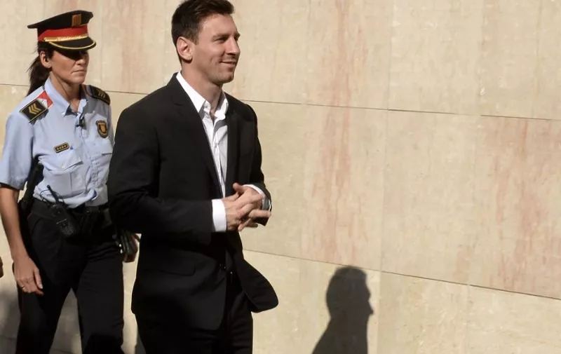 (FILES) A picture taken on September 27, 2013 shows Barcelona's Argentinian forward Lionel Messi arriving at the courthouse in the coastal town of Gava near Barcelona to face judges on tax evasion charges. Argentina and Barcelona star Lionel Messi and his father Jorge are to stand trial on three counts of tax fraud that could carry prison sentences, a Spanish court confirmed on October 8, 2015. In a court filing, the judge in charge of the case rejected the request of the public prosecutor to try only the footballer's father. The pair were accused in 2013 of defrauding the taxman out of 4.16 million euros ($4.69 million) in taxes related to Messi's image rights between 2007 and 2009 through the creation of fake companies in Belize and Uruguay.  AFP PHOTO/ LLUIS GENE