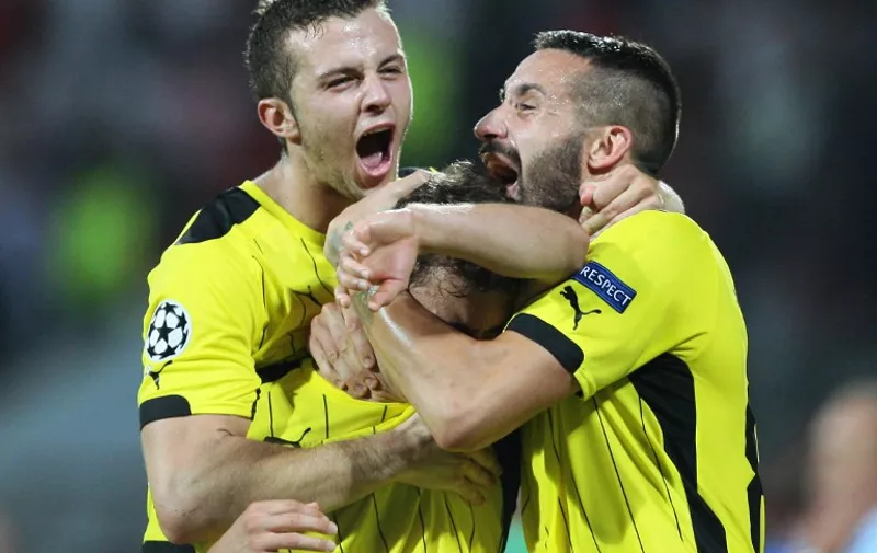 Zagreb's French defender Jérémy Taravel (R) and teammates celebrate after scoring the second goal during the UEFA Champions League playoff football match between KF Skenderbeu and Dinamo Zagreb at the Elbansan Arena in Elbasan, Albania on August 19, 2015. Dinamo Zagreb won the match 1-2. AFP PHOTO / GENT SHKULLAKU