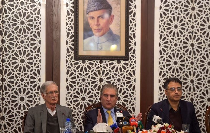 Pakistani Foreign Minister Shah Mehmood Qureshi (C) speaks next to Defence Minister Pervez Khattak (L) and Finance Minister Asad Umar (R) during a press conference at the Foreign Affairs Ministry in Islamabad on February 26, 2019, following the Indian Air Force (IAF) strike launched on a Jaish-e-Mohammad (JeM) camp at Balakot. - Pakistan rejected February 26 India's claim that it killed many militants in an air strike, branding it "self serving, reckless and fictitious". Pakistan officials have said that Indian warplanes did breach its airspace and drop a payload over Balakot in the country's northwest, but said there was no damage or casualties. (Photo by AAMIR QURESHI / AFP)