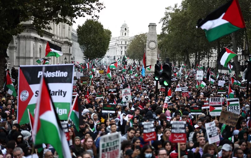 People take part in a 'March For Palestine', in London on October 21, 2023, to "demand an end to the war on Gaza". The UK has pledged its support for Israel following the bloody attacks by Hamas, which killed more than 1,400 people, and has announced that humanitarian aid to the Palestinians will be increased by a third -- an extra £10 million pounds ($12 million). Israel is relentlessly bombing the small, crowded territory of Gaza, where more than 3,400 people have been killed, most of them Palestinian civilians, according to the local authorities. (Photo by HENRY NICHOLLS / AFP)