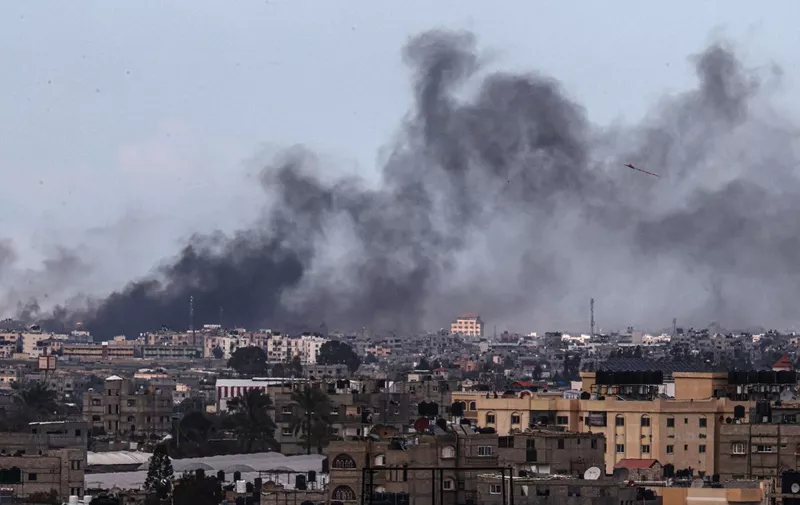 This picture taken from Rafah shows smoke billowing following Israeli bombardment over Khan Yunis in the southern Gaza Strip on February 15, 2024, amid the ongoing conflict between Israel and the Palestinian Hamas militant group. (Photo by SAID KHATIB / AFP)