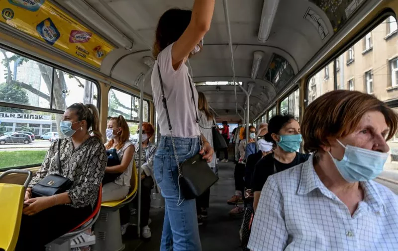 Passengers travel wearing facemasks on a tram in Zagreb on June 25, 2020, as the wearing of masks on public transport in Croatia became mandatory on June 23, due to an increase of coronavirus infections after the relaxation of lockdown conditions.,Image: 535656726, License: Rights-managed, Restrictions: , Model Release: no