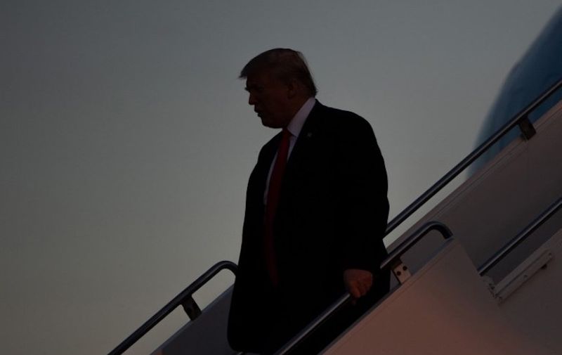 US President Donald Trump disembarks from Air Force One upon arrival at Southwest Florida International Airport in Fort Myers, Florida, on October 31, 2018, as he travels for a campaign rally. (Photo by SAUL LOEB / AFP) / ALTERNATIVE CROP