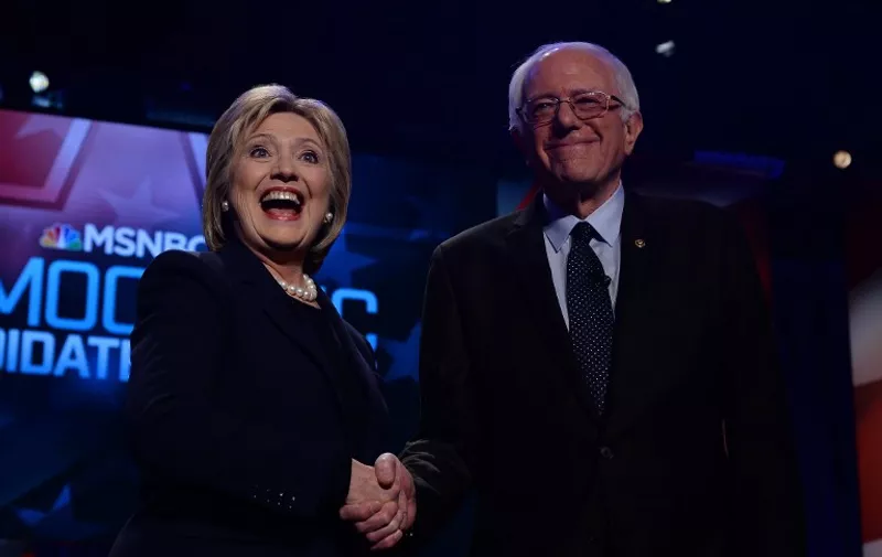 US Democratic presidential candidates Hillary Clinton and Bernie Sanders shake hands before participating in the MSNBC Democratic Candidates Debate at the University of New Hampshire in Durham on February 4, 2016. 
Clinton and Sanders face off on February 4, in the first debate since their bruising Iowa clash that the former secretary of state won by a hair, as they gear for a battle royale in New Hampshire. / AFP / JEWEL SAMAD