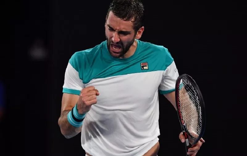 Croatia's Marin Cilic Britain's reacts after a point against Kyle Edmund during their men's singles semi-finals match on day 11 of the Australian Open tennis tournament in Melbourne on January 25, 2018. / AFP PHOTO / Greg Wood / -- IMAGE RESTRICTED TO EDITORIAL USE - STRICTLY NO COMMERCIAL USE --