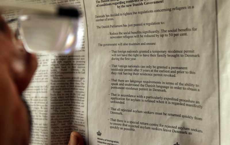 A Lebanese man looks at an advertisement published in the "Daily Star" Lebanese daily newspaper in English by the Danish Ministry of Immigration and Integration to warn would-be migrants about new and tighter restrictions on those seeking asylum in the country on September 8, 2015 in Beirut. Denmark has placed adverts in at least three Arabic-language newspapers and one English-language daily in Lebanon on September 7, 2015 cautioning that "Denmark has decided to tighten the regulations concerning refugees in a number of areas". AFP PHOTO / JOSEPH EID