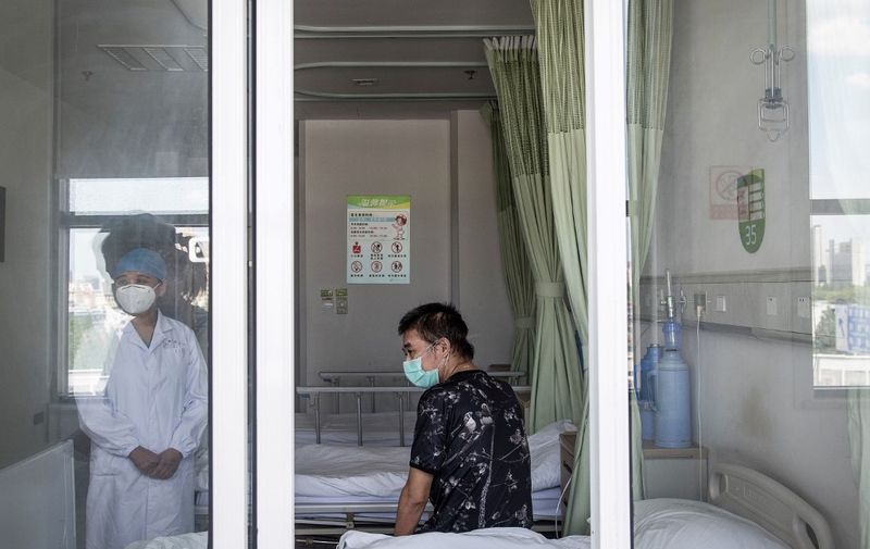 This photo taken on June 17, 2020 shows a man, who is the last patient recovered from the COVID-19 coronavirus infection in the Wuhan pulmonary hospital, looking on before he leaves the hospital in Wuhan, in China's central Hubei province. (Photo by STR / AFP) / China OUT