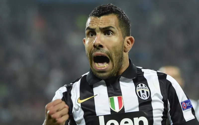 Juventus' forward from Argentina Carlos Tevez celebrates after scoring a penalty kick during the UEFA Champions League semi-final first leg football match Juventus vs Real Madrid on May 5, 2015 at the Juventus stadium in Turin.   AFP PHOTO / OLIVIER MORIN