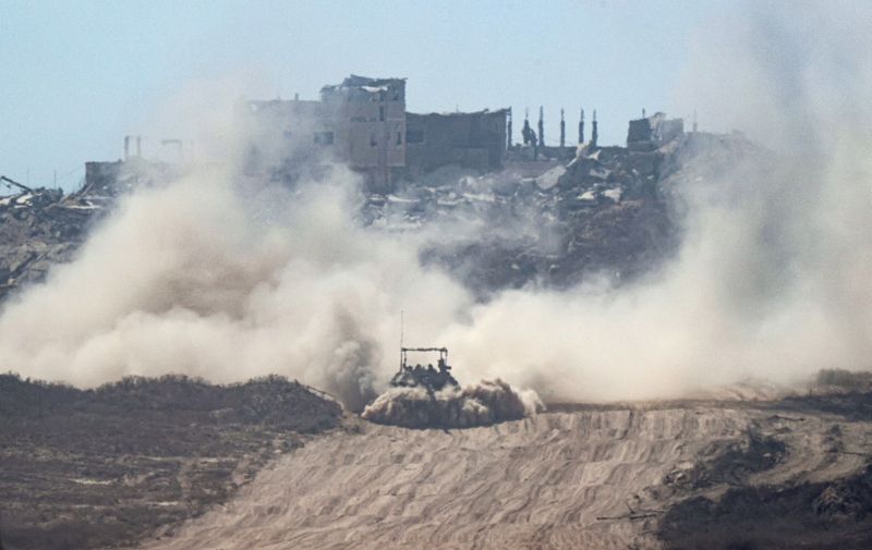 An Israeli tank drives through the Gaza Strip along the Israel's southern border with the Palestinian territory on July 2, 2024, amid the ongoing conflict between Israel and the Palestinian militant group Hamas. (Photo by JACK GUEZ / AFP)