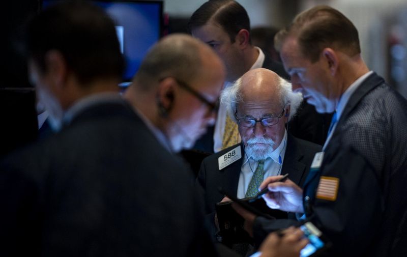 Traders work after the closing bell at the New York Stock Exchange (NYSE) on Wall Street in New York City on May 23, 2019. (Photo by Johannes EISELE / AFP)