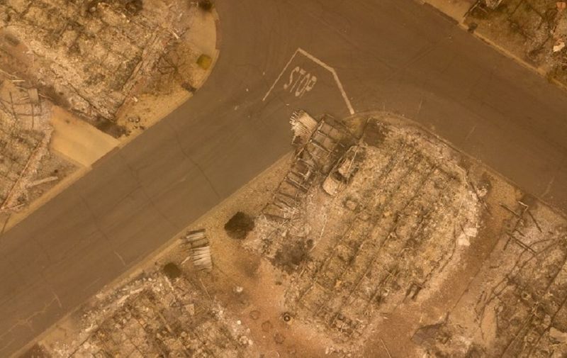 In this aerial photo, a burned neighborhood is seen in Paradise, California on November 15, 2018. - The toll in the deadliest wildfires in recent California history climbed to 59 on November 14, 2018, as authorities released a list of 130 people still missing. (Photo by Josh Edelson / AFP)