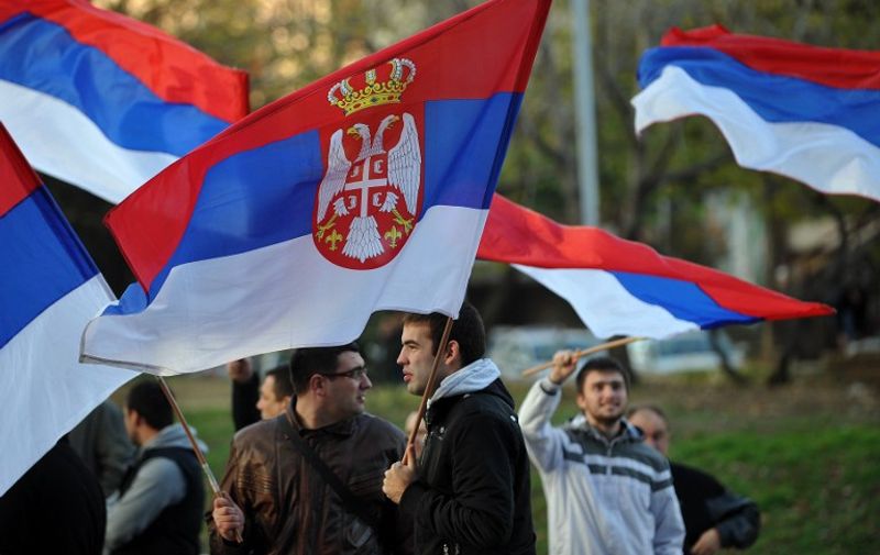 Supporters of nationalist movement Dveri wave Serbian national flags in front of the EU delegation premises in Belgrade, on November 17, 2012. Several hundred Serbian nationalists today burned Croatia's flag during a protest against a UN court acquitting two Croatian generals of war crimes against ethnic Serbs in the 1990s.  AFP PHOTO / ANDREJ ISAKOVIC