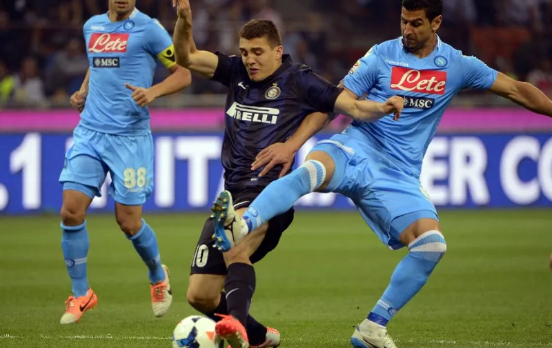 Inter Milan's Croatian midfielder Mateo Kovacic (L) fights for the ball with Napoli's Uruguayan defender Angel Miguel Britos during the Italian Seria A football match Inter Milan vs  Naples, on April 26, 2014 at the San Siro stadium in Milan. AFP PHOTO / OLIVIER MORIN