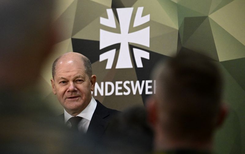 German Chancellor Olaf Scholz is pictured next to the Bundeswehr logo as he  addresses military personnel as part of his first visit to the Territorial Command of the German Armed Forces Bundeswehr at the Julius Leber Barracks in Berlin, Germany on February 28, 2023. - The new command was set up in September 2022 and is responsible for the management and coordination of Bundeswehr operations in Germany - from homeland security to coordinating the deployment of our own or allied troops to setting up a crisis management team in the Chancellery. (Photo by Tobias SCHWARZ / AFP)