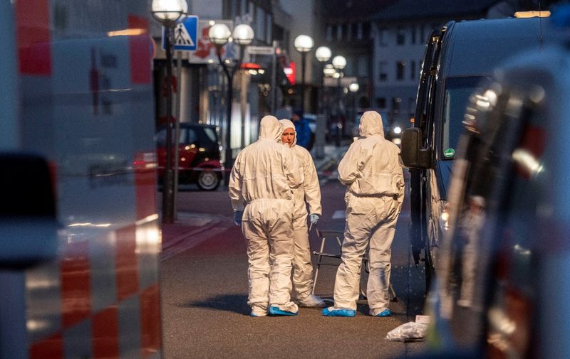 Forensic police are seen at the crime scene in front of a bar and a shisha bar at the Heumarkt in the centre of Hanau, near Frankfurt am Main, western Germany, on February 20, 2020, after at least nine people were killed in two shootings late on February 19. - At least nine people were killed in shootings targeting shisha bars in Germany that sparked a huge manhunt overnight before the suspected gunman was found dead in his home early on February 20. The attacks occurred at two bars in Hanau, about 20 kilometres (12 miles) from Frankfurt, where armed police quickly fanned out and police helicopters roamed the sky looking for those responsible for the bloodshed. Police in the central state of Hesse said the likely perpetrator had been found at his home in Hanau after they located a getaway vehicle seen by witnesses. Another body was also discovered at the property. German counter-terror prosecutors said on February 20 they had taken over the investigation into two linked shootings. (Photo by Thomas Lohnes / AFP)