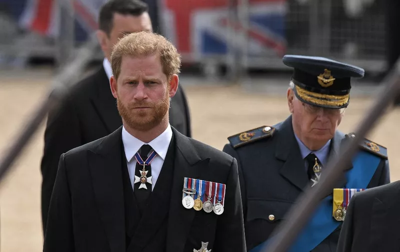 Britain's Prince Harry, Duke of Sussex follows the coffin of Queen Elizabeth II, draped in the Royal Standard, as it travels on the State Gun Carriage of the Royal Navy, from Westminster Abbey to Wellington Arch in London on September 19, 2022, after the State Funeral Service of Britain's Queen Elizabeth II. (Photo by LOIC VENANCE / AFP)