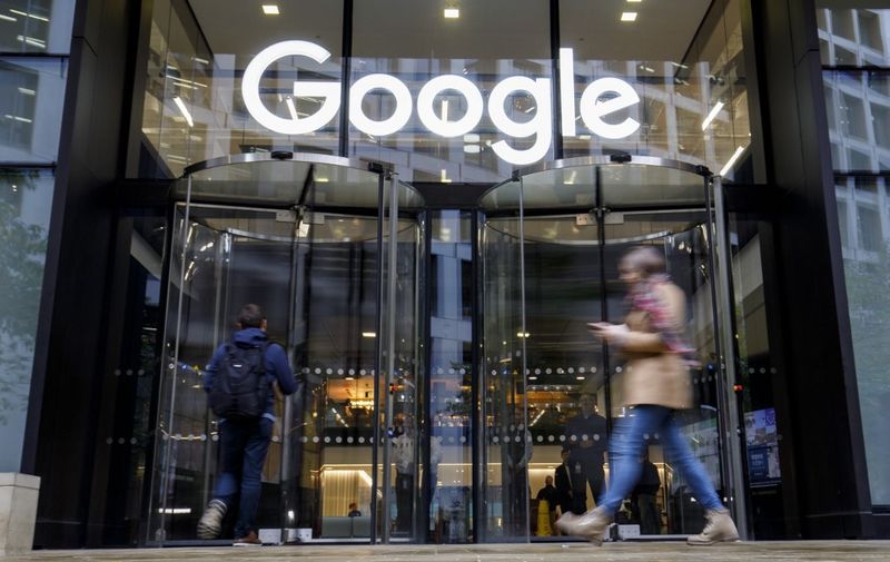 People walk past Google's UK headquarters in London on November 1, 2018. - Hundreds of employees walked out of Google's European headquarters in Dublin on Thursday as part of a global campaign over the US tech giant's handling of sexual harassment that saw similar protests in London and Singapore. (Photo by Tolga Akmen / various sources / AFP)