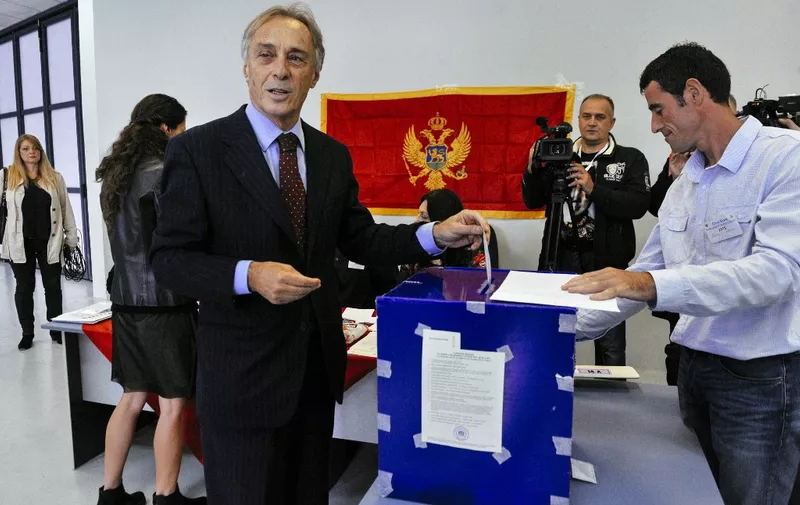 Miodrag Lekic, leader of the opposition coalition DEMOS casts his ballot during parliamentary elections at a polling station in Podgorica on October 16, 2016. - Montenegro began voting in parliamentary elections on October 16, 2016 with opposition groups hoping to end the quarter-century rule of pro-Western premier Milo Djukanovic, who warns that his rivals would derail imminent NATO accession. (Photo by SAVO PRELEVIC / AFP)