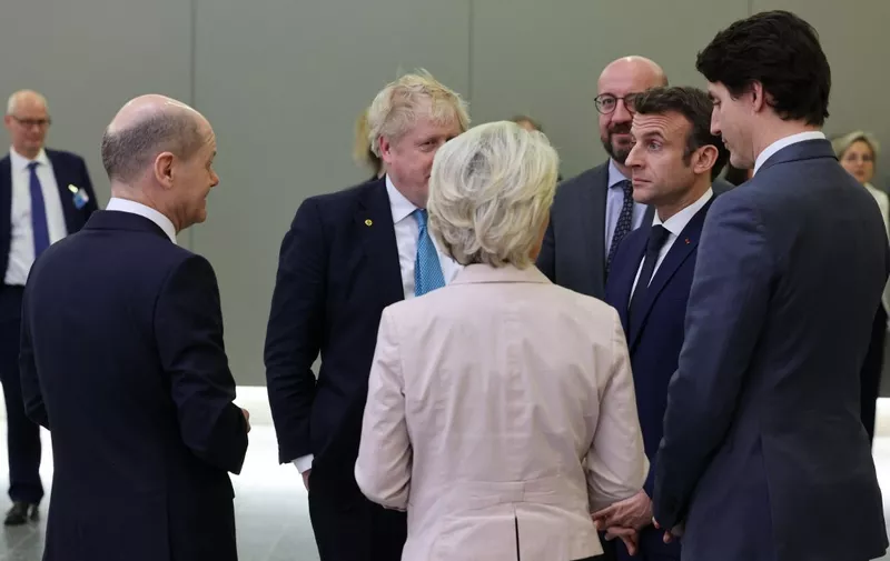 German Chancellor Olaf Scholz (L), Britain's Prime Minister Boris Johnson (2nd -L), President of the European Commission Ursula von der Leyen (C) European Council President Charles Michel ( 3rd - R), France's President Emmanuel Macron ( 2nd - R) and Canada's Prime Minister Justin Trudeau talk ahead of a G7 summit in Brussels on March 24, 2022. (Photo by Thomas COEX / POOL / AFP)