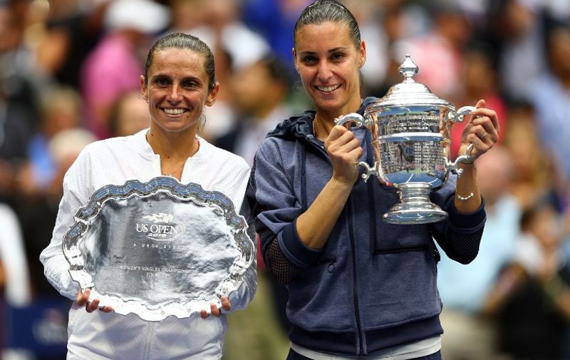 NEW YORK, NY - SEPTEMBER 12: Flavia Pennetta (R) of Italy and Roberta Vinci (L) of Italy pose with their trophies after their Women's Singles Final match on Day Thirteen of the 2015 US Open at the USTA Billie Jean King National Tennis Center on September 12, 2015 in the Flushing neighborhood of the Queens borough of New York City. Pennetta defeated Vinci 7-6, 6-2.   Clive Brunskill/Getty Images/AFP