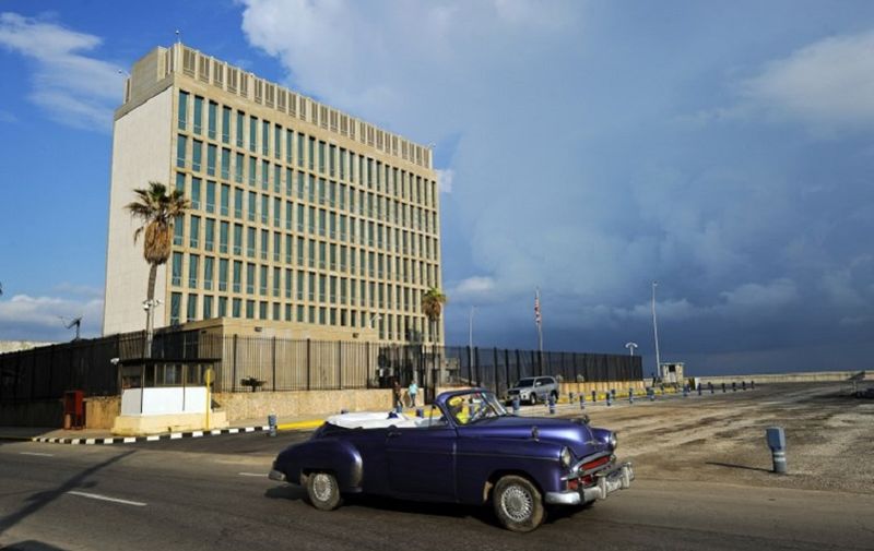 An old American car passes by the US Embassy in Havana on December 17, 2015. The United States announced Thursday the resumption of regular flights to and from Cuba, the latest step in a historic thaw in relations. "On December 16, the United States and Cuba reached a bilateral arrangement to establish scheduled air services between the two countries," the State Department said in a statement. / AFP PHOTO / YAMIL LAGE