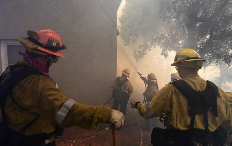 Firefighters work to protect a building at Mt. Wilson Observatory as the Bobcat Fire burns in the Angeles National Forest, northeast of Los Angeles, California on September 17, 2020. - The Bobcat Fire erupted on September 6 near the Cogswell Dam and West Fork Day Use area northeast of Mount Wilson within the Angeles National Forest, expanding from 46,263 acres to 50,539 acres since September 16 while remaining only 3% contained. (Photo by Frederic J. BROWN / AFP)