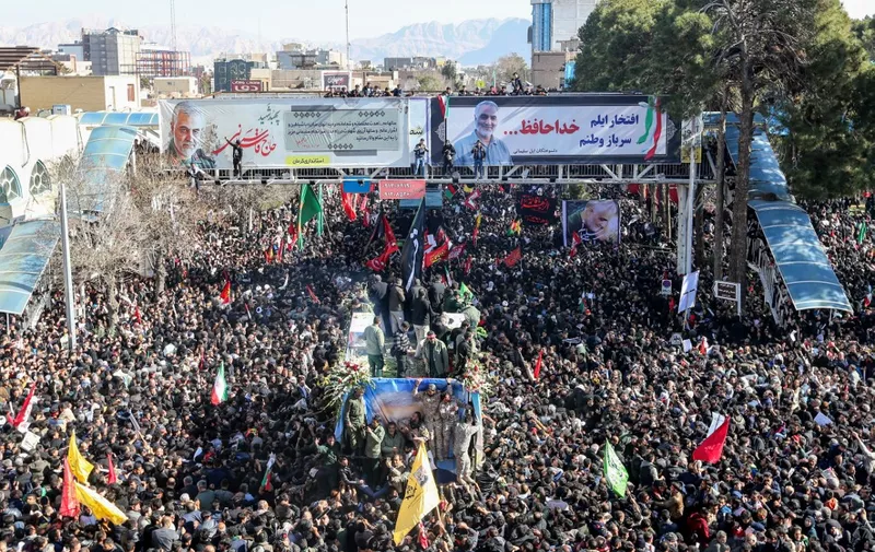 Iranian mourners gather around a vehicle carrying the coffin of slain top general Qasem Soleimani during the final stage of funeral processions, in his hometown Kerman on January 7, 2020. - Soleimani was killed outside Baghdad airport on January 3 in a drone strike ordered by US President Donald Trump, ratcheting up tensions with arch-enemy Iran which has vowed "severe revenge". The assassination of the 62-year-old heightened international concern about a new war in the volatile, oil-rich Middle East and rattled financial markets. (Photo by ATTA KENARE / AFP)