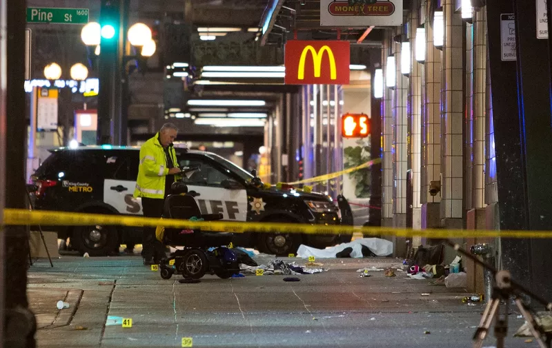 A crime-scene investigator inspects the scene of a shooting that left one person dead and seven injured, including a child, in downtown Seattle, Washington on January 22, 2020. At least one person was killed and seven others, including a child, were wounded on Wednesday after gunfire broke out in downtown Seattle near a popular tourist area, police and hospital officials said. Police said at least one suspect was being sought in connection with the mass shooting that took place near a McDonald's fast food restaurant, just blocks away from the Pike Place Market., Image: 494338237, License: Rights-managed, Restrictions: Graphic Content, Model Release: no, Credit line: Jason Redmond / AFP / Profimedia