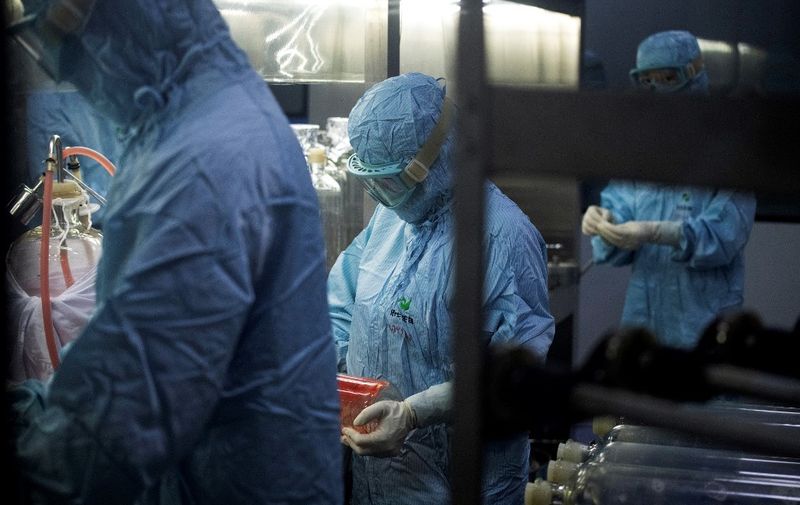 Researchers in protective suits work in a lab at the Yisheng Biopharma company, where researchers are trying to develop a vaccine for the COVID-19 coronavirus, in Shenyang, in Chinas northeast Liaoning province, on June 9, 2020. - China has mobilised its army and fast-tracked tests in the global race to find a coronavirus vaccine, and is involved in several of the dozen or so international clinical trials currently under way. (Photo by NOEL CELIS / AFP)