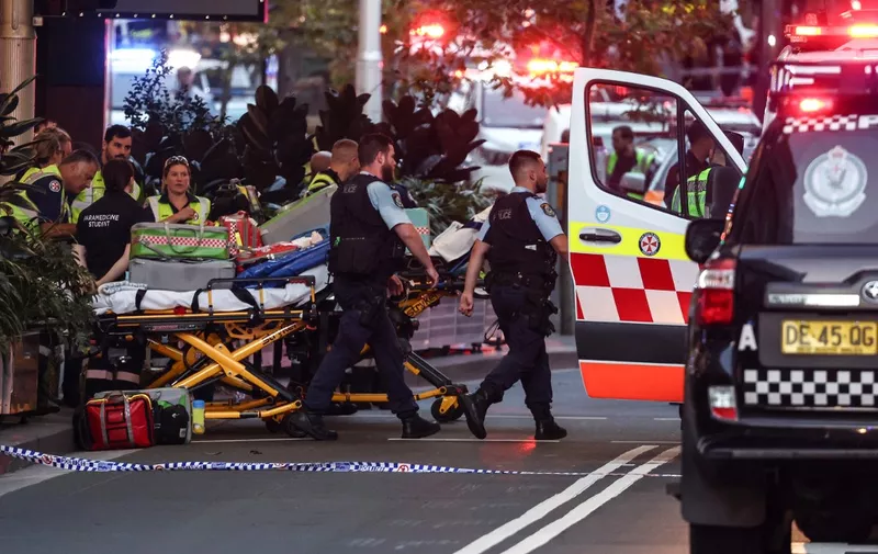Police and paramedics work outside the Westfield Bondi Junction shopping mall after a stabbing incident in Sydney on April 13, 2024. Australian police on April 13 said they had received reports that "multiple people" were stabbed at a busy shopping centre in Sydney. (Photo by David GRAY / AFP)