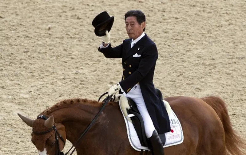 Japan'son Whisper salutes spectators after competing in the Dressage preliminaries of the London 2012 Olympic Games at the equestrian venue in Greenwich Park, London, on August 2, 2012.  / AFP / JOHN MACDOUGALL