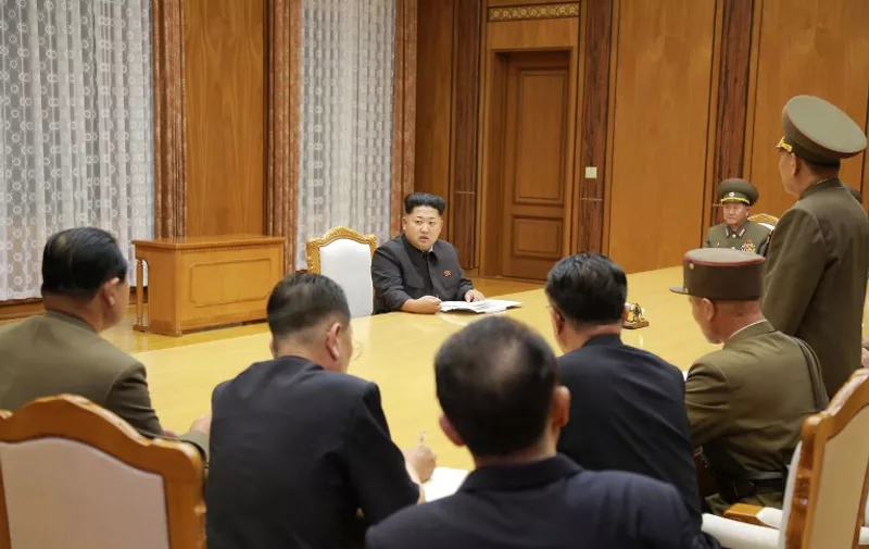 This picture taken by North Korea's official Korean Central News Agency (KCNA) on August 20, 2015 shows North Korean leader Kim Jong-Un (C) attending an emergency enlarged meeting of the Workers' Party of Korea (WPK) Central Military Commission at undisclosed place in North Korea. Kim Jong-Un ordered his frontline troops onto a war-footing from on August 21, as military tensions with South Korea soared following a rare exchange of artillery shells across their heavily fortified border.     AFP PHOTO / KCNA via KNS    REPUBLIC OF KOREA OUT
THIS PICTURE WAS MADE AVAILABLE BY A THIRD PARTY. AFP CAN NOT INDEPENDENTLY VERIFY THE AUTHENTICITY, LOCATION, DATE AND CONTENT OF THIS IMAGE. THIS PHOTO IS DISTRIBUTED EXACTLY AS RECEIVED BY AFP.
---EDITORS NOTE--- RESTRICTED TO EDITORIAL USE - MANDATORY CREDIT "AFP PHOTO / KCNA VIA KNS" - NO MARKETING NO ADVERTISING CAMPAIGNS - DISTRIBUTED AS A SERVICE TO CLIENTS