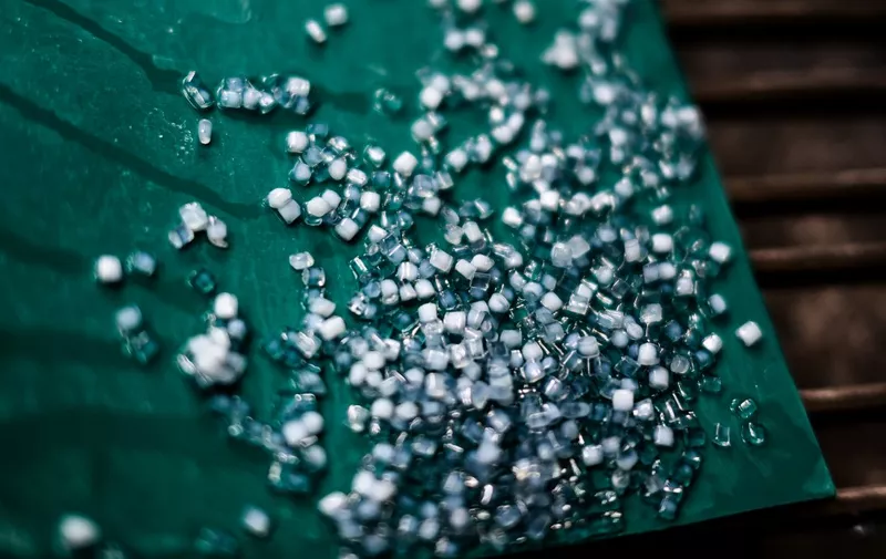 PET plastic pellets are pictured on a recycling line of the Plastipak Infineo recycling plant in Saint-Marie-La-Blanche, central eastern France, on June 1, 2023. (Photo by JEFF PACHOUD / AFP)
