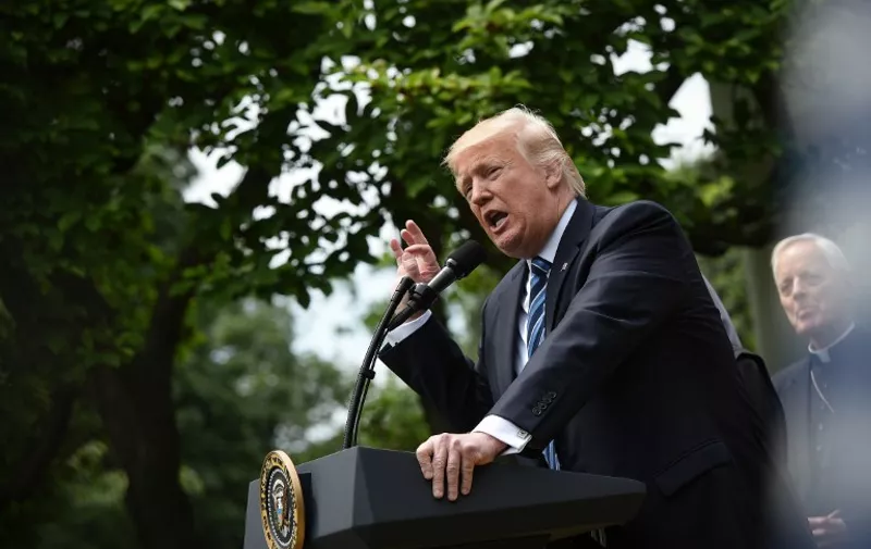 US President Donald Trump speaks before signing an Executive Order on Promoting Free Speech and Religious Liberty in the Rose Garden of the White House on May 4, 2017 in Washington, DC.
Trump issued an executive order on Thursday making it easier for churches and religious groups to take part in politics without risk of losing their tax-exempt status, a senior White House official said. / AFP PHOTO / MANDEL NGAN