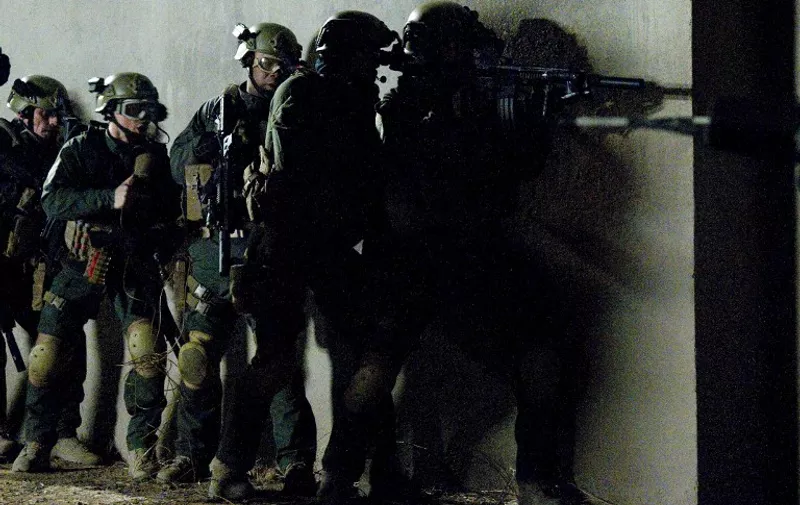 This still photo from  "SEAL Team Six: The Killing of Osama bin Laden" shows a dramatization of the night raid on Osama Bin Laden's compound on May 2, 2011 in the Pakistani city of Abbottabad.  Timing is everything in show business, but the director of the first movie about the commando raid that killed Osama bin Laden doubts its television premiere Sunday, November 4, 2012, will swing the US election. "SEAL Team Six: The Killing of Osama bin Laden" raised eyebrows when it was announced last month that it would screen for the first time on the National Geographic cable channel just two days before America votes.  AFP PHOTO / Geronimo Nevada, LLC. / National Geographic Channels / Ursula COYOTE    == RESTRICTED TO EDITORIAL  USE / MANDATORY CREDIT:  "AFP PHOTO / Geronimo Nevada, LLC. / National Geographic Channels / Ursula COYOTE" / NO SALES / NO MARKETING / NO ADVERTISING CAMPAIGNS / DISTRIBUTED AS A SERVICE TO CLIENTS ==