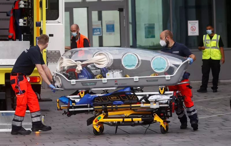 (FILES) In this file photo taken on August 22, 2020 German army emergency personnel load into their ambulance the stretcher that was used to transport Russian opposition figure Alexei Navalny on at Berlin's Charite hospital, where Navalny will be treated after his medical evacuation to Germany following a suspected poisoning. - Navalny's test results 'indicate poisoning' and long-term effects 'cannot be ruled out', Berlin hospital on August 24, 2020 said. (Photo by Odd ANDERSEN / AFP)