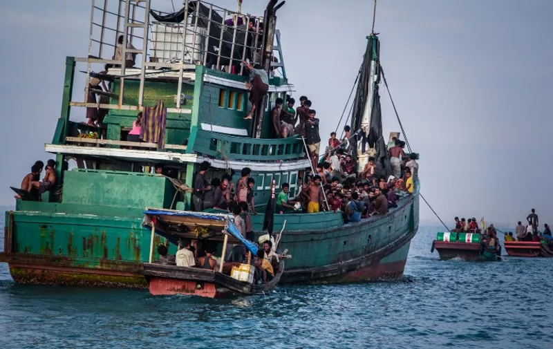 In this photo taken on May 20, 2015 shows Rohingya migrants resting on a boat off the coast near Kuala Simpang Tiga in Indonesia's East Aceh district of Aceh province before being rescued. Indonesia's foreign minister demanded answers from Canberra about claims Australian officials paid thousands of dollars to turn a boat back to Indonesia after Prime Minister Tony Abbott refused to deny the allegations. AFP PHOTO / JANUAR