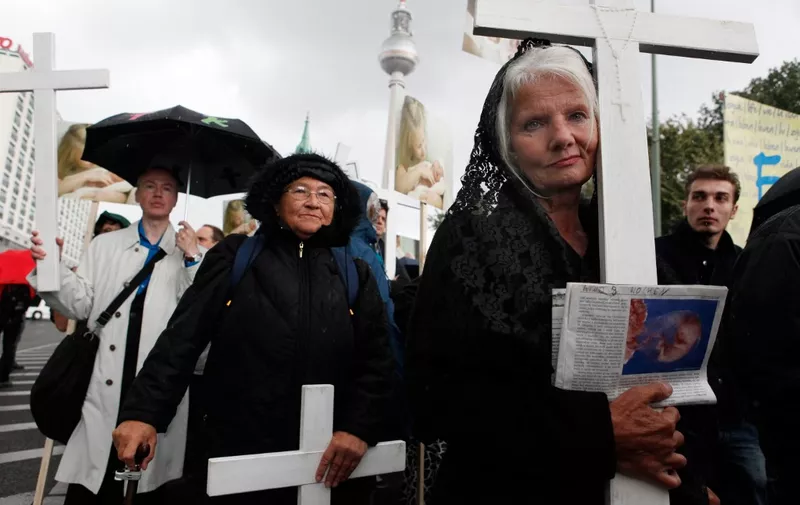 Anti-abortion activists carry crucifixes during a march on September 18, 2010 in Berlin. The rally was met by counter-demonstrations by pro-choice activists and feminists.  AFP PHOTO / DAVID GANNON (Photo by DAVID GANNON / AFP)