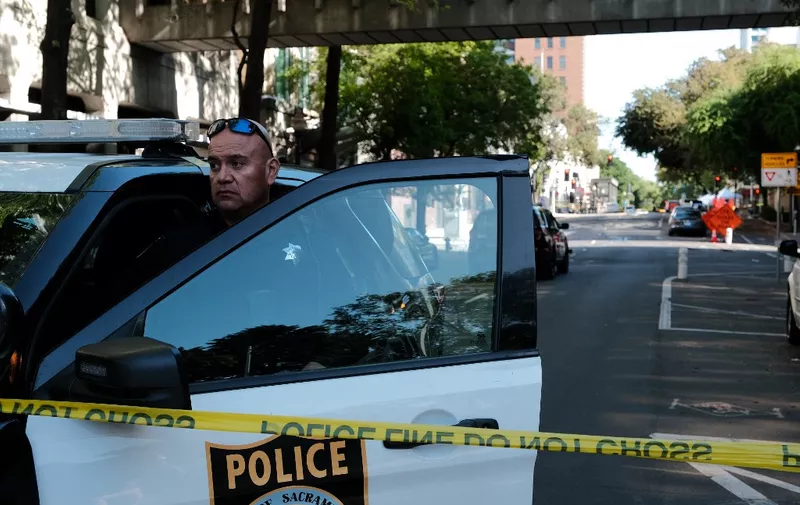 SACRAMENTO, CALIFORNIA APRIL 03: Police officers work the scene of a shooting on the corner of 10th and L street that occurred in the early morning hours on April 3, 2022 in Sacramento, California. Six people were killed and at least 10 were injured in the mass shooting in downtown Sacramento with no suspects in custody.   David Odisho/Getty Images/AFP (Photo by David Odisho / GETTY IMAGES NORTH AMERICA / Getty Images via AFP)
