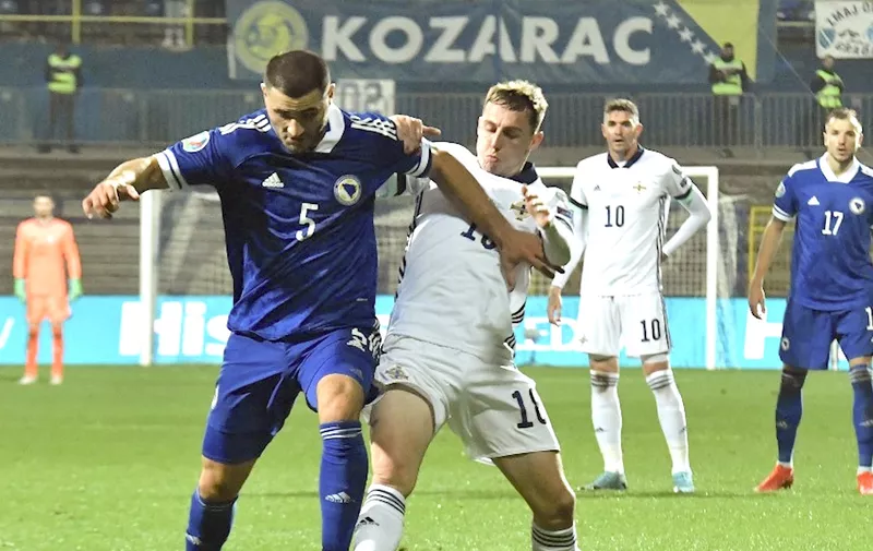 Bosnia and Herzegovina's defender Sead Kolasinac (L) vies with Northern Ireland's forward Kyle Lafferty (R) during the UEFA Euro 2020 Play-off Semi-Final football match between Bosnia and Herzegovina and Northern Ireland in Sarajevo on October 8, 2020. (Photo by ELVIS BARUKCIC / AFP)