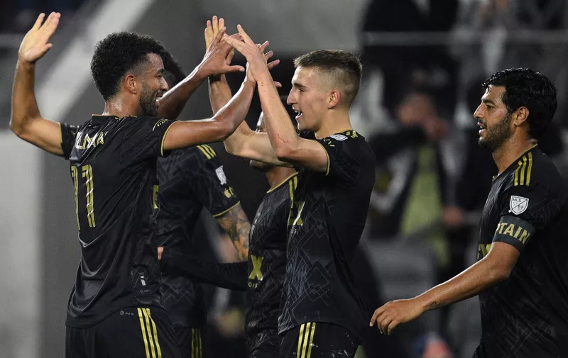 Mar 12, 2023; Los Angeles, California, USA; Los Angeles FC forward Stipe Biuk (7) is congratulated by midfielder Timothy Tillman (11) after scoring a goal during the second half against the New England Revolution at BMO Stadium. Mandatory Credit: Orlando Ramirez-USA TODAY Sports