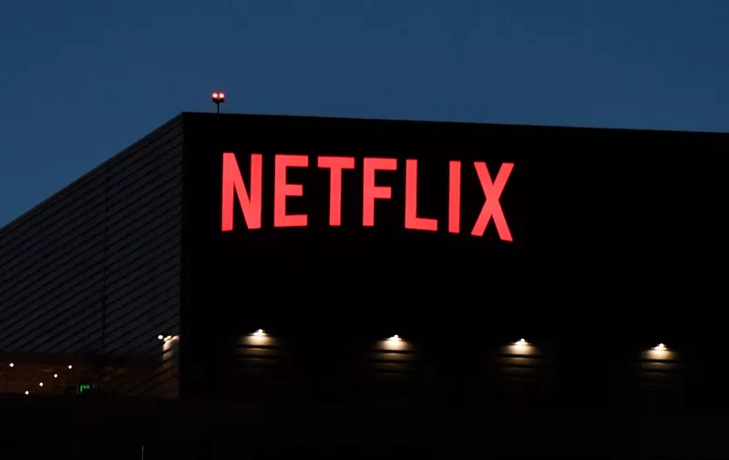 The Netflix logo is seen on the Netflix, Inc. building on Sunset Boulevard in Los Angeles, California on October 19, 2021. Netflix reported billion-dollar profits and booming subscriber growth on October 19 that beat forecasts as global hits like Squid Game drew viewers in droves. (Photo by Robyn Beck / AFP)