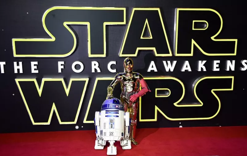 Star Wars drones C-3PO and R2-DT attend the opening of the European Premiere of "Star Wars: The Force Awakens" in central London on December 16, 2015. Ever since 1977, when "Star Wars" introduced the world to The Force, Jedi knights, Darth Vader, Wookiees and clever droids R2-D2 and C3PO, the sci-fi saga has built a devoted global fan base that spans the generations. 
AFP PHOTO / LEON NEAL / AFP / LEON NEAL
