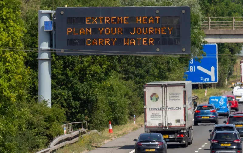 Picture dated July 18th shows the warning sign  on the M11 near Cambridge  after the extreme heat arrived on Monday.

The King's Lynn to London King's Cross train was seen emerging through the heat haze near Ely in Cambridgeshire this morning (Mon) after the Met Office issued a red extreme heat warning.

London North Eastern Railway (LNER) trains are travelling at half their normal speed between London King's Cross and Leeds today with temperatures set to hit 40C in parts of the UK.

Trains usually run at 125mph on this section of the line, but have been limited to 60mph due to a high risk of rails buckling.

Tomorrow LNER has confirmed it will close the East Coast Main Line between Leeds and London King's Cross, with temperatures set to soar even higher.
Motorway warning for heatwave, Cambridge, UK - 18 Jul 2022,Image: 708340264, License: Rights-managed, Restrictions: , Model Release: no, Credit line: Profimedia