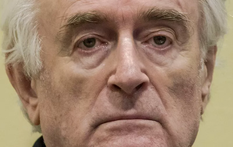 Former Bosnian Serb leader Radovan Karadzic reacts at the court room of the International Residual Mechanism for Criminal Tribunals in The Hague, Netherlands, on March 20, 2019, while waiting to hear the final judgement on his role in the bloody conflict that tore his country apart a quarter of a century ago.
  Karadzic was notorious for his role in the 1995 Srebrenica massacre where more than 8,000 Muslim men and boys were slaughtered in the worst bloodletting on European soil since World War II. In one of the last remaining cases from the break-up of Yugoslavia, UN judges in The Hague will rule on his appeal against his 2016 conviction for genocide and war crimes, and his 40-year jail sentence.,Image: 420795210, License: Rights-managed, Restrictions: , Model Release: no